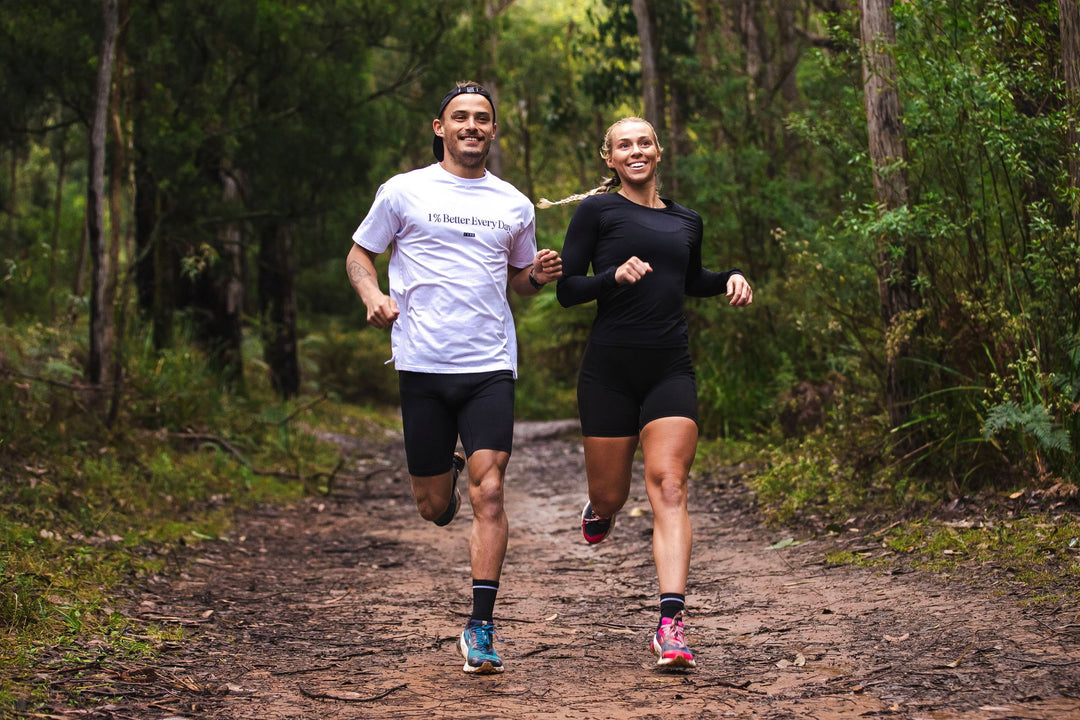 girl and boy running a trail