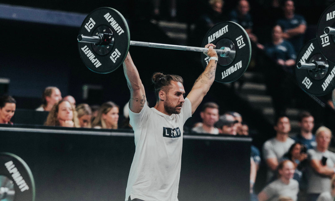 man lifting a weight above his head