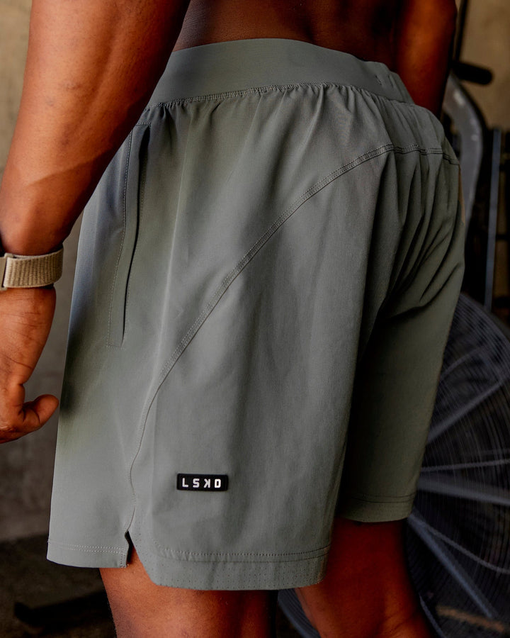 Man wearing Challenger 6" Lined Performance Shorts - Graphite