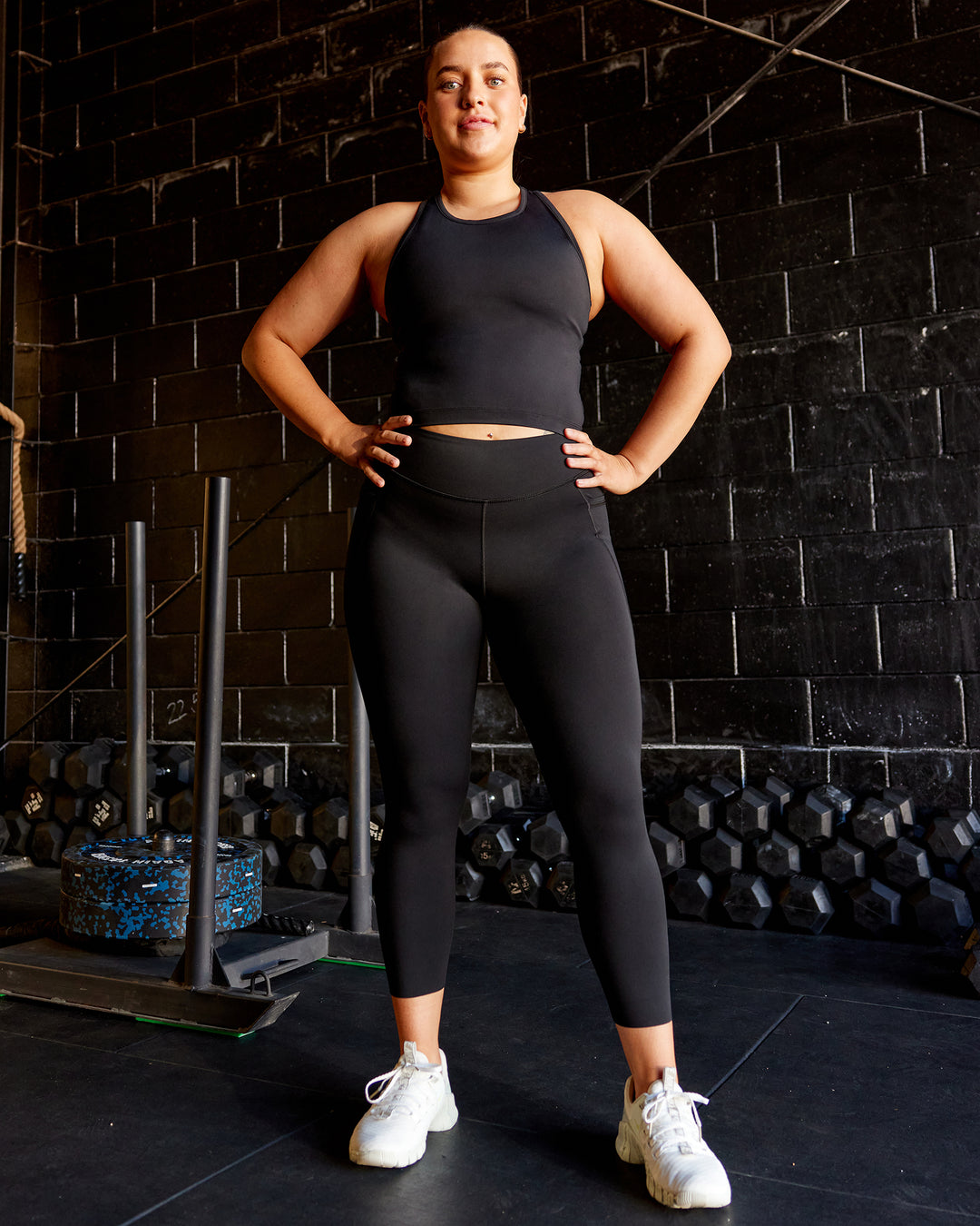 Woman wearing Elite High-Rise 7/8 Legging Pockets - Black