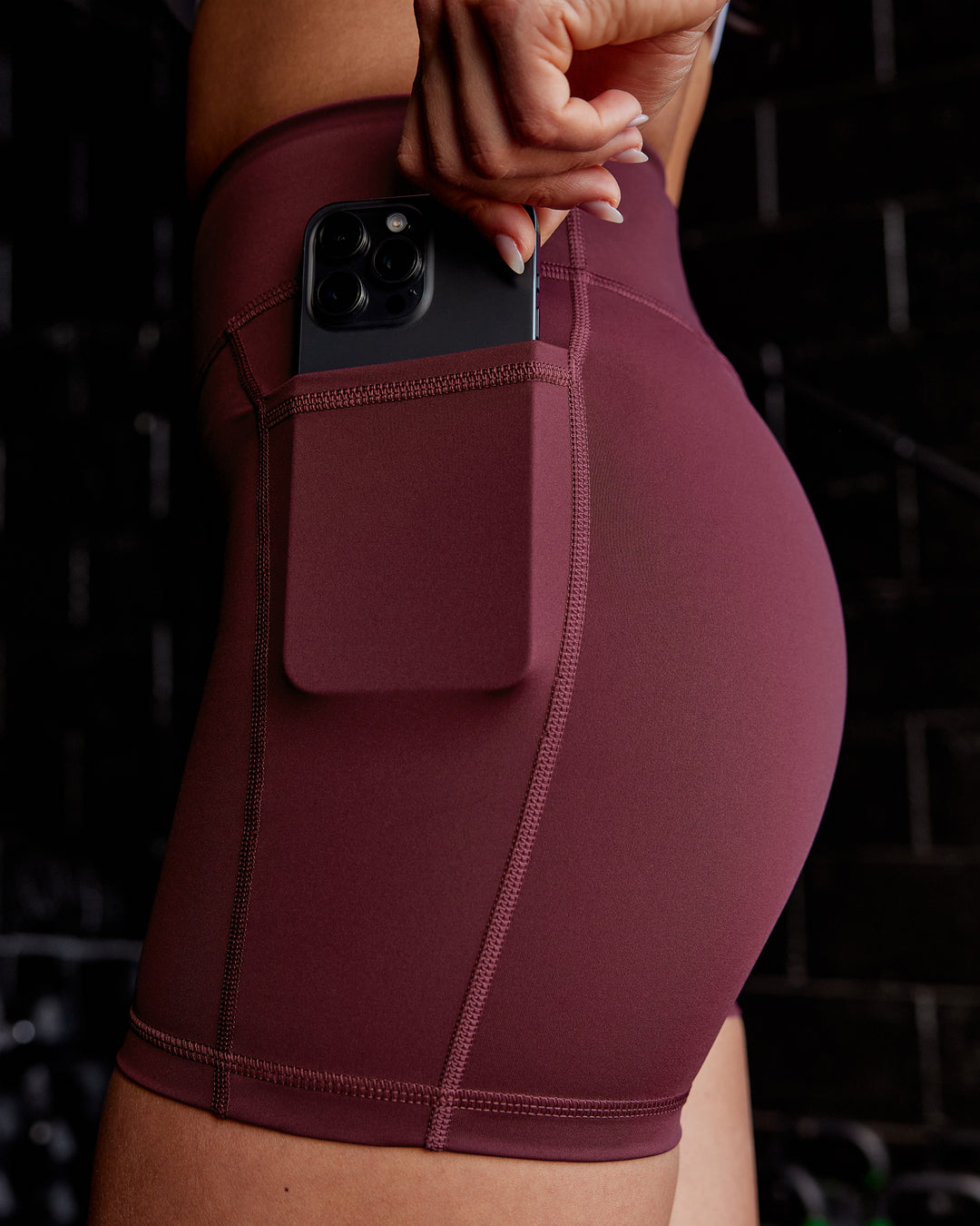 Woman wearing Elite High-Rise 4" Short Pockets - Dark Cherry