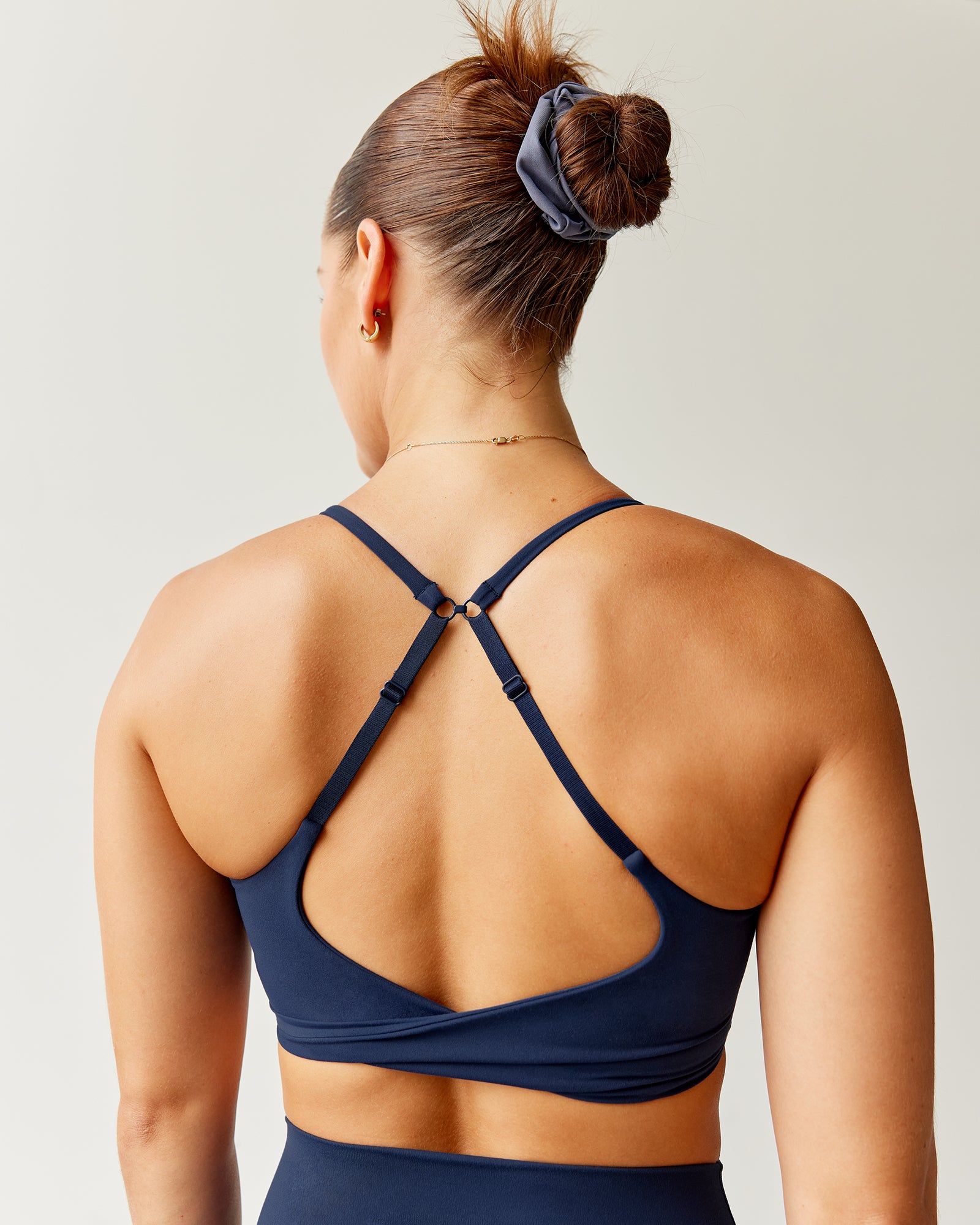 Woman wearing Twist Sports Bra - Future Navy | Model:Abbey | Size:S