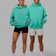 Duo wearing Unisex Love The Run Hoodie Oversize - Aquatic Awe-White