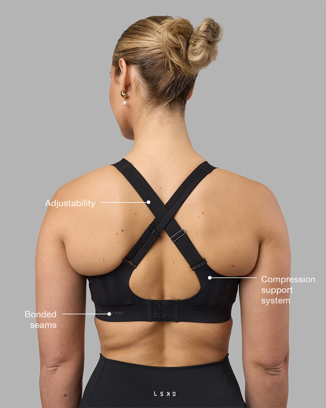 Woman wearing Stability Sports Bra - Black | Model:Amy | Size:S (D-E Cup)