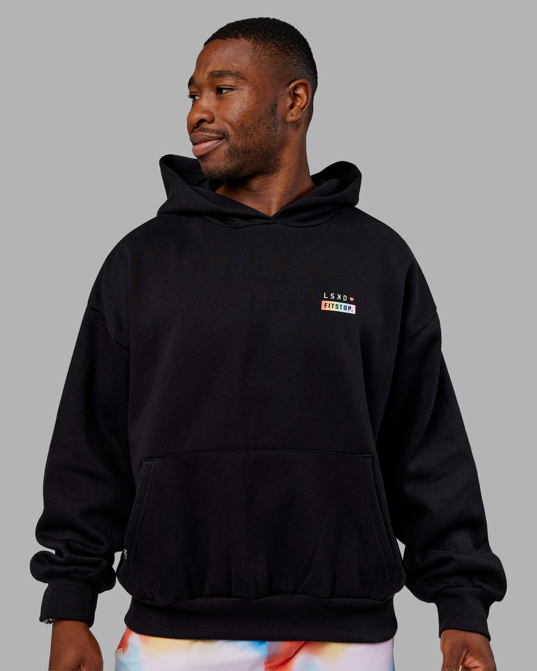 Man wearing Fitstop Unstoppable Together Oversized Hoodie - Black | Model:Sam | Size:L