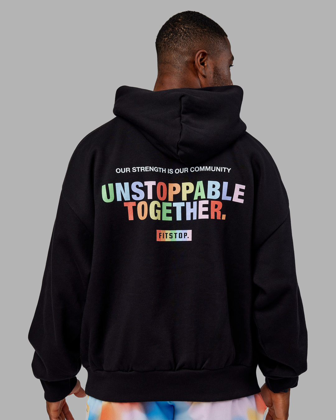 Man wearing Fitstop Unstoppable Together Oversized Hoodie - Black | Model:Sam | Size:L
