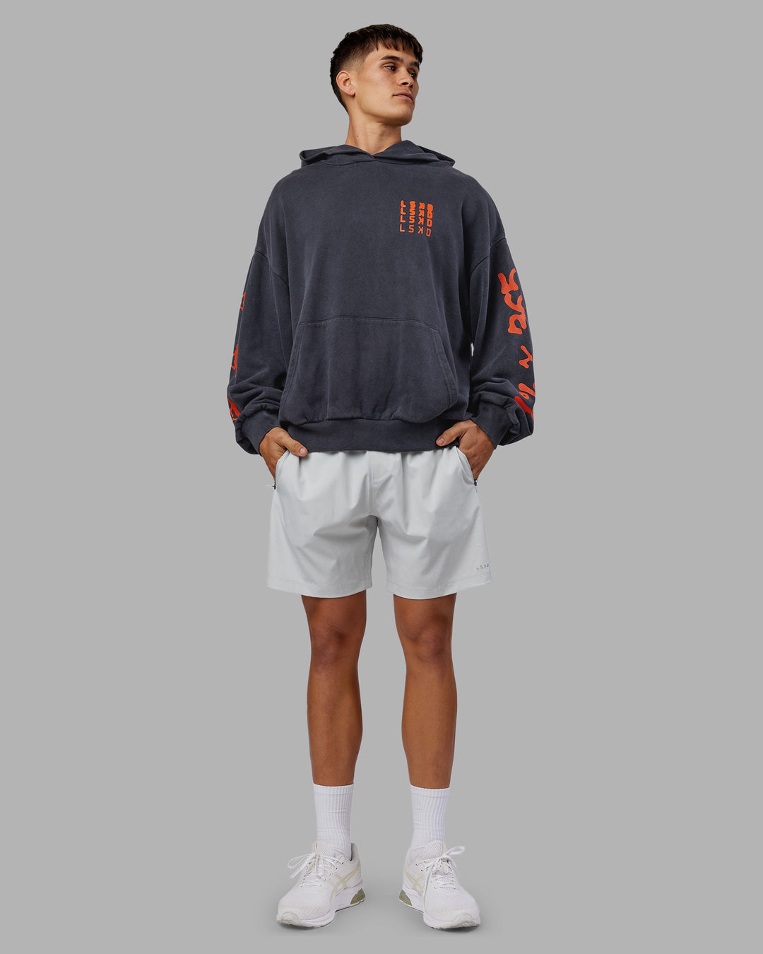 Man wearing Journey Washed Unisex Oversize Hoodie - Black-Ultra Orange | Model:Jackson | Size:L
