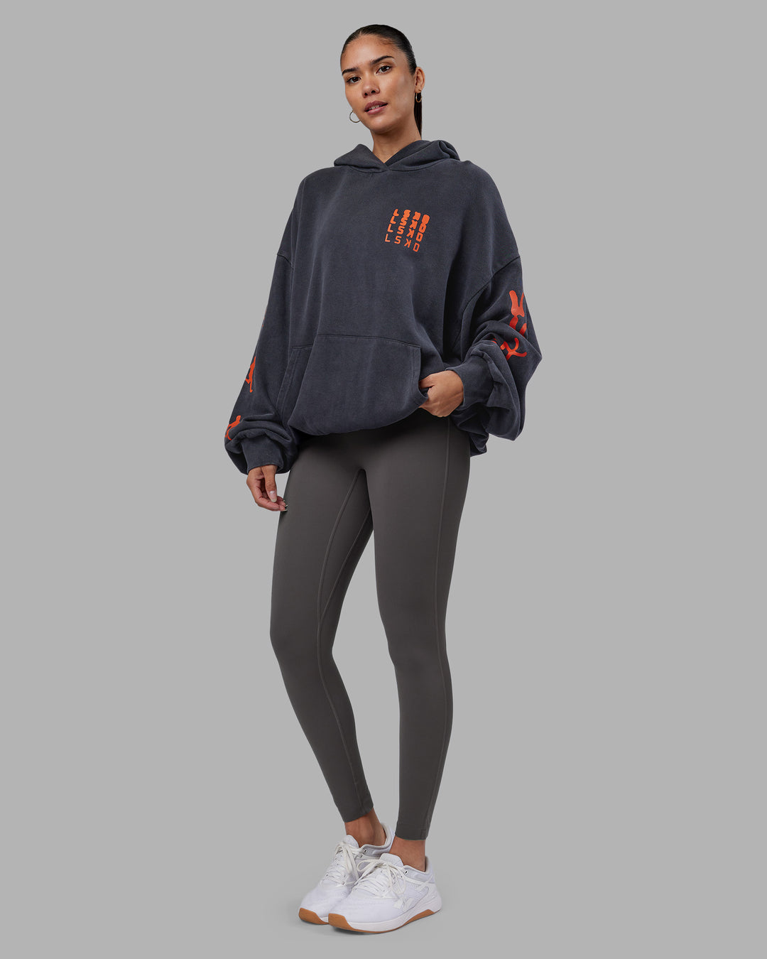 Woman wearing Journey Washed Unisex Oversize Hoodie - Black-Ultra Orange | Model:Rhiley | Size:L