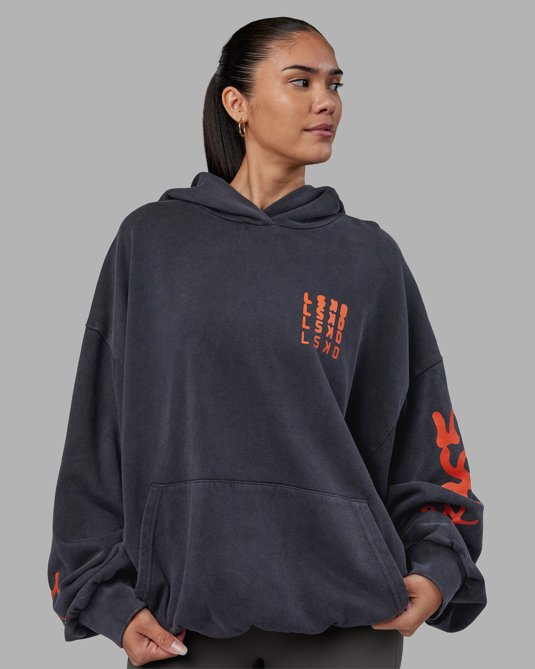 Woman wearing Journey Washed Unisex Oversize Hoodie - Black-Ultra Orange | Model:Rhiley | Size:L