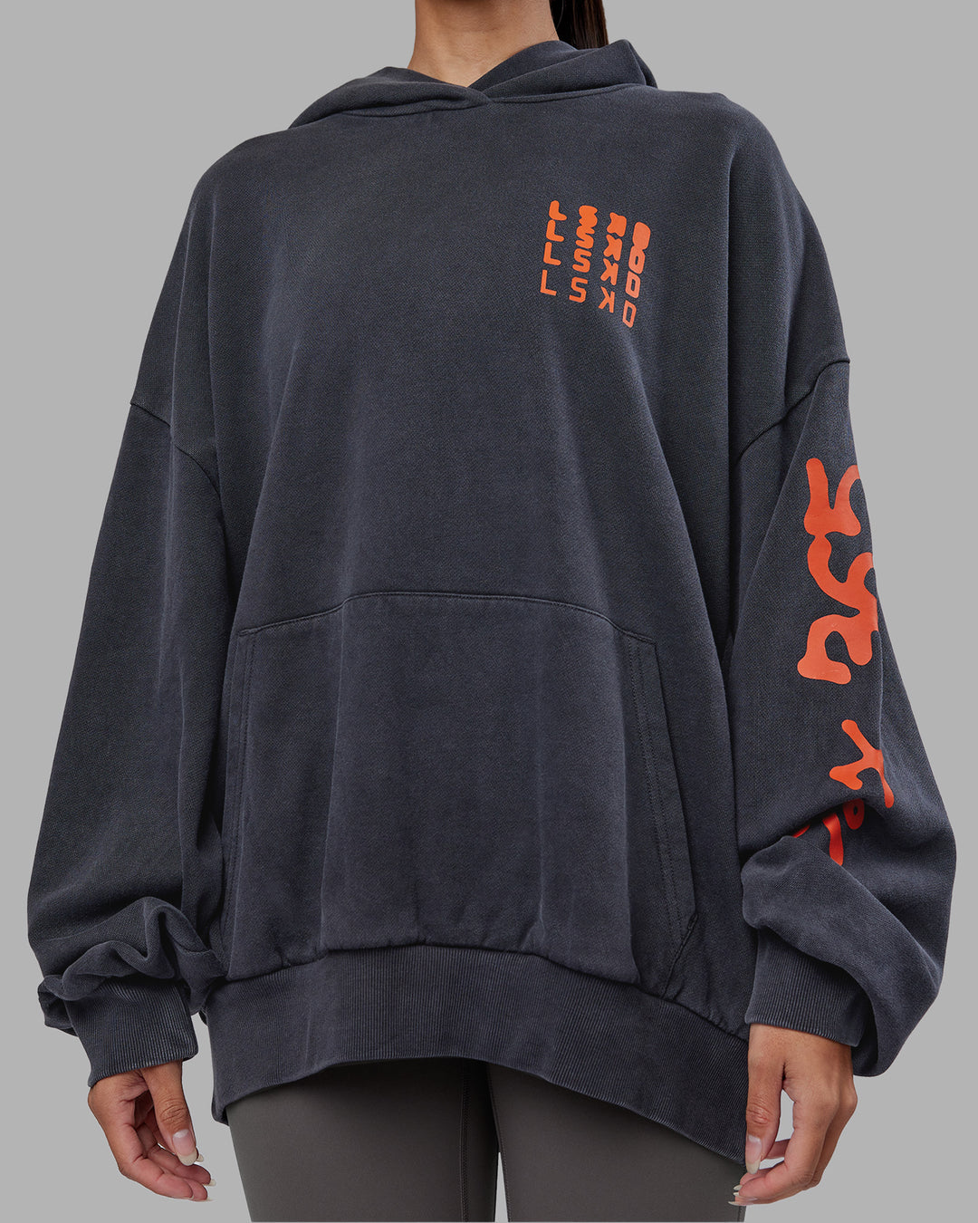 Woman wearing Journey Washed Unisex Oversize Hoodie - Black-Ultra Orange | Model:Rhiley | Size:L