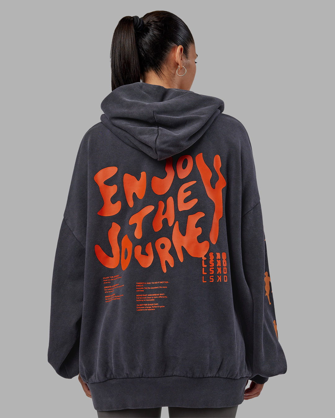 Woman wearing Journey Washed Unisex Oversize Hoodie - Black-Ultra Orange | Model:Rhiley | Size:L
