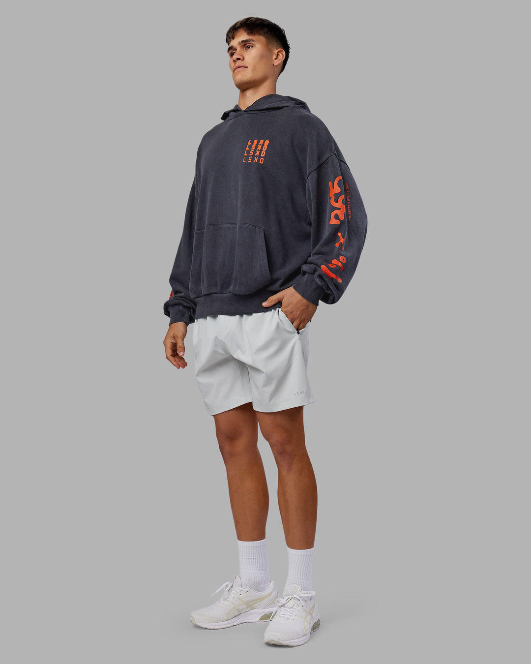 Man wearing Journey Washed Unisex Oversize Hoodie - Black-Ultra Orange | Model:Jackson | Size:L