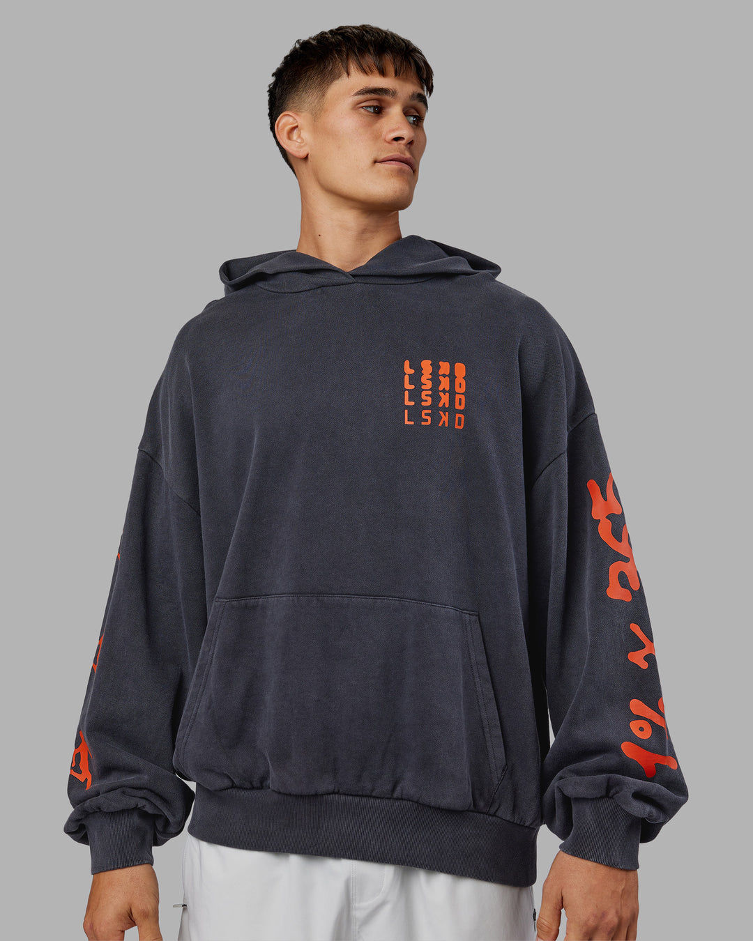 Man wearing Journey Washed Unisex Oversize Hoodie - Black-Ultra Orange | Model:Jackson | Size:L
