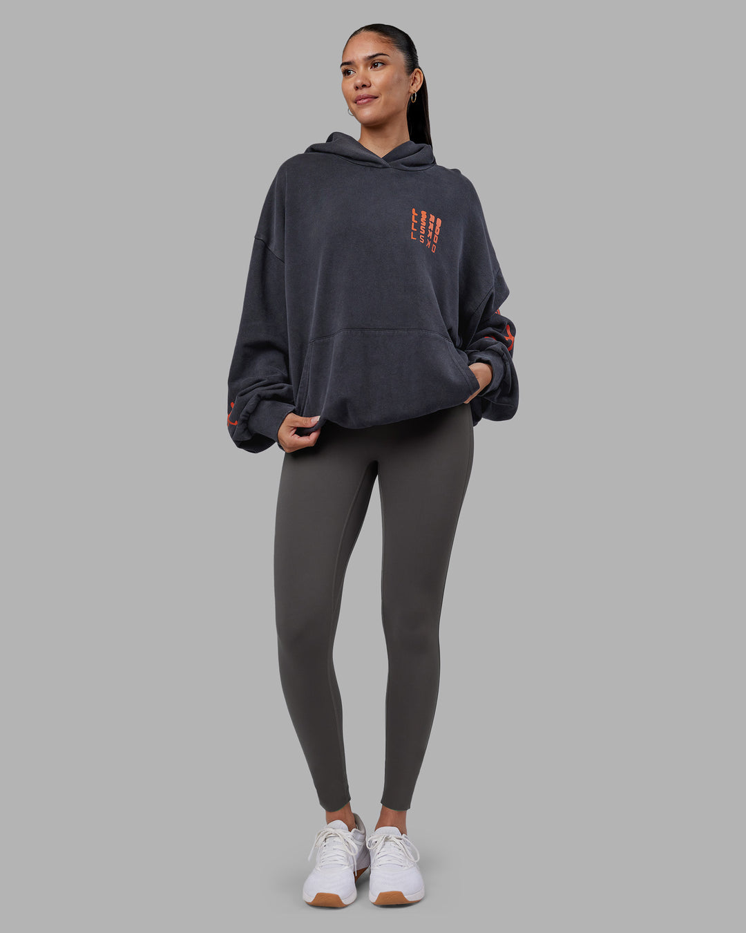 Woman wearing Journey Washed Unisex Oversize Hoodie - Black-Ultra Orange | Model:Rhiley | Size:L