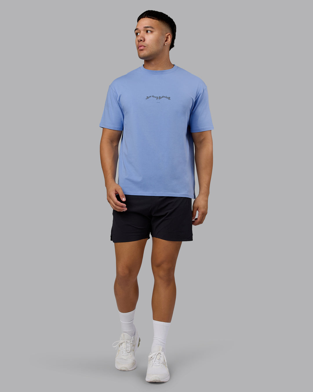 Man wearing Just Run FLXCotton Oversized Tee - Soft Blue-Dark Storm | Model:Kaelyb | Size:L