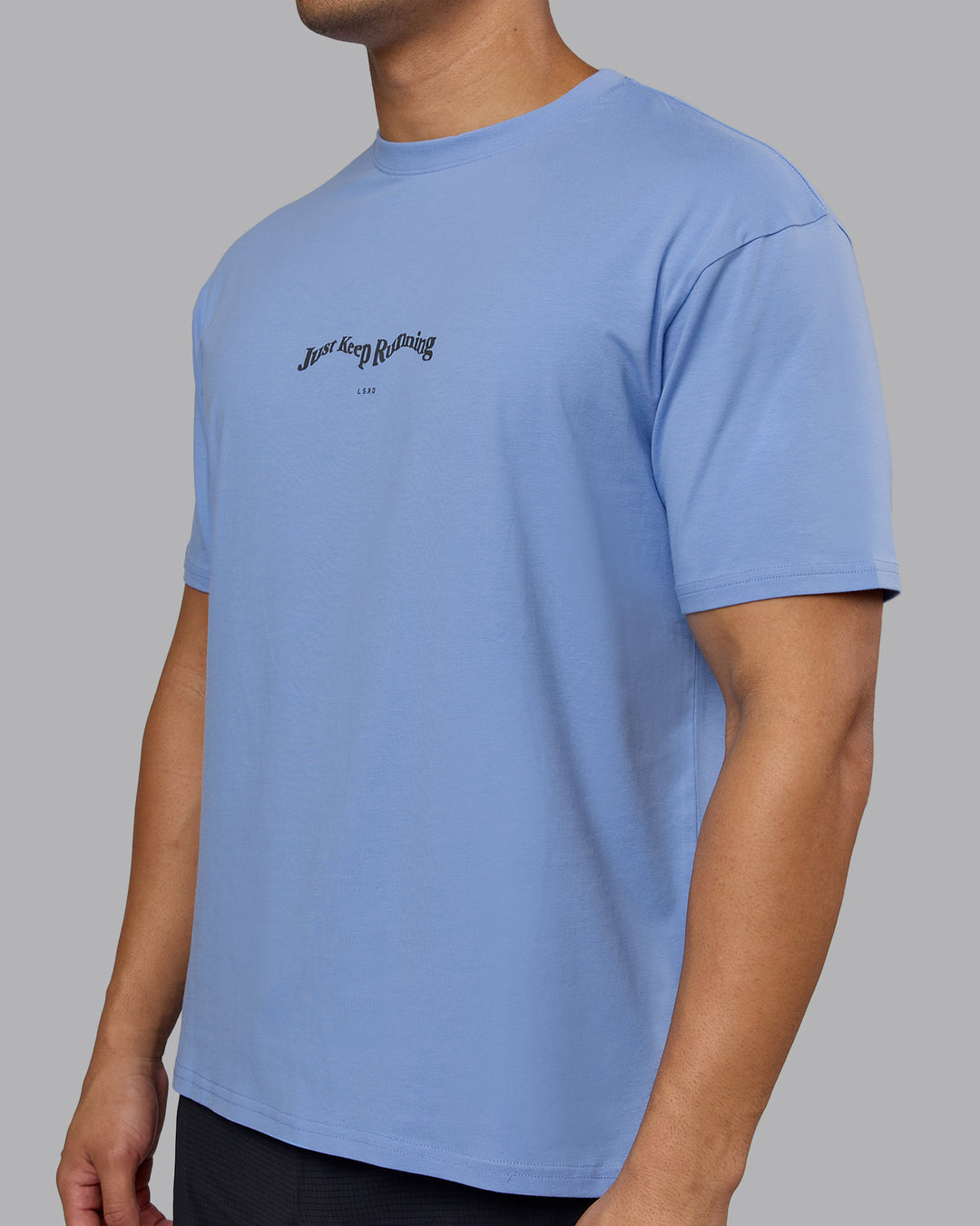 Man wearing Just Run FLXCotton Oversized Tee - Soft Blue-Dark Storm | Model:Kaelyb | Size:L