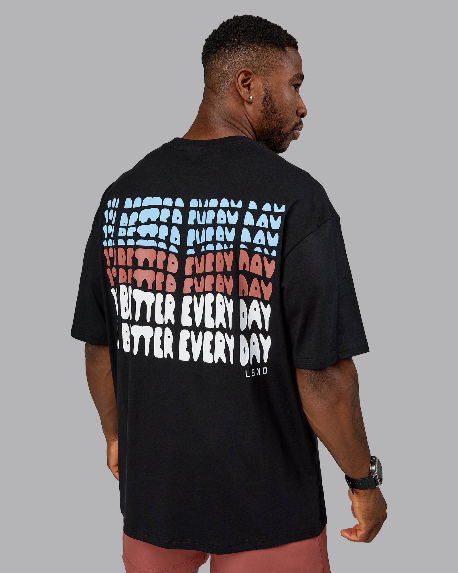 Man wearing On Repeat FLXCotton Oversized Tee - Black-Mahogany | Model:Sam | Size:L
