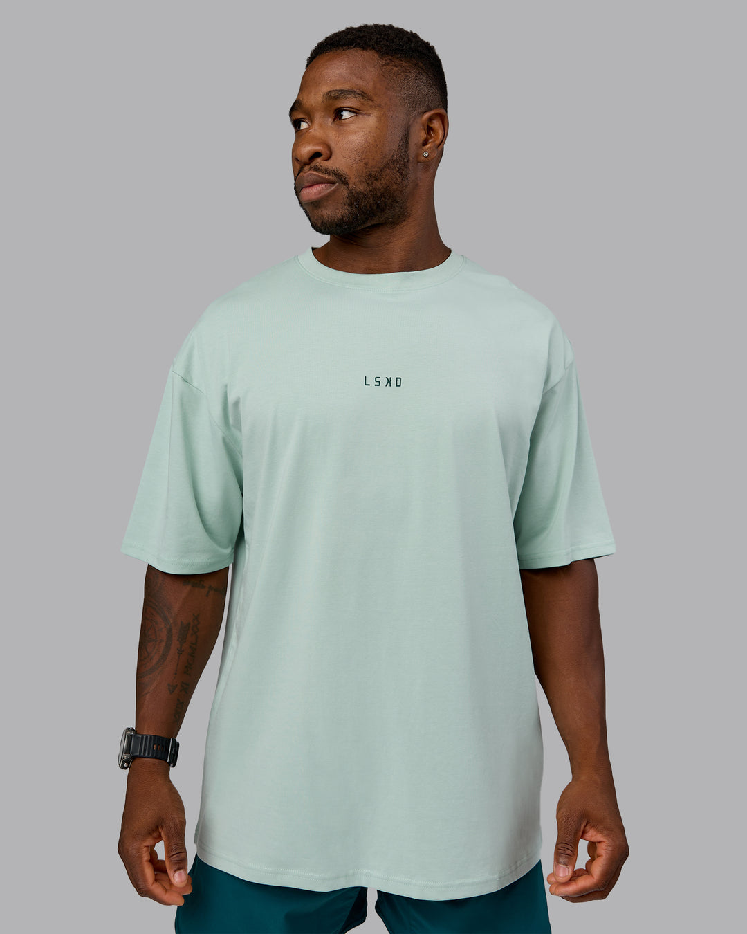 Man wearing On Repeat FLXCotton Oversized Tee - Blue Haze-Dark Moss | Model:Sam | Size:L