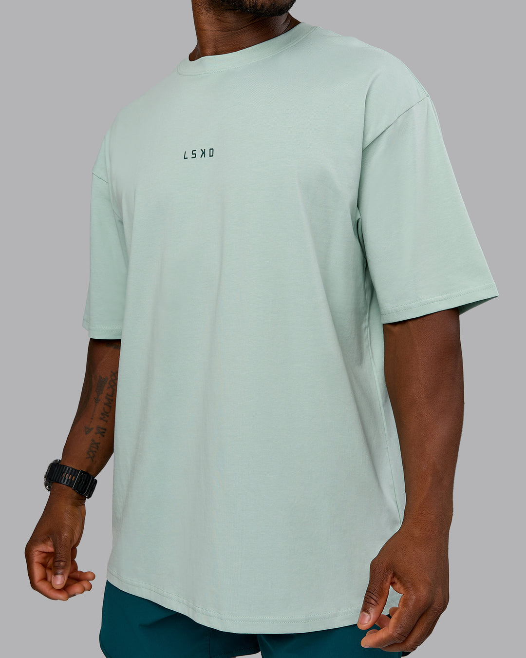 Man wearing On Repeat FLXCotton Oversized Tee - Blue Haze-Dark Moss | Model:Sam | Size:L