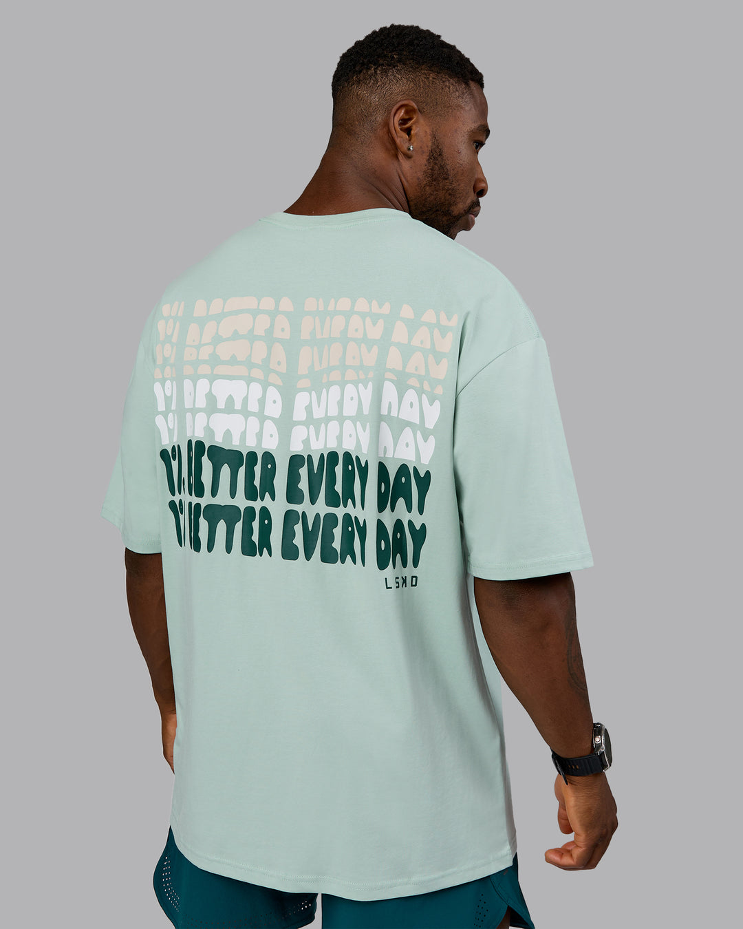 Man wearing On Repeat FLXCotton Oversized Tee - Blue Haze-Dark Moss | Model:Sam | Size:L