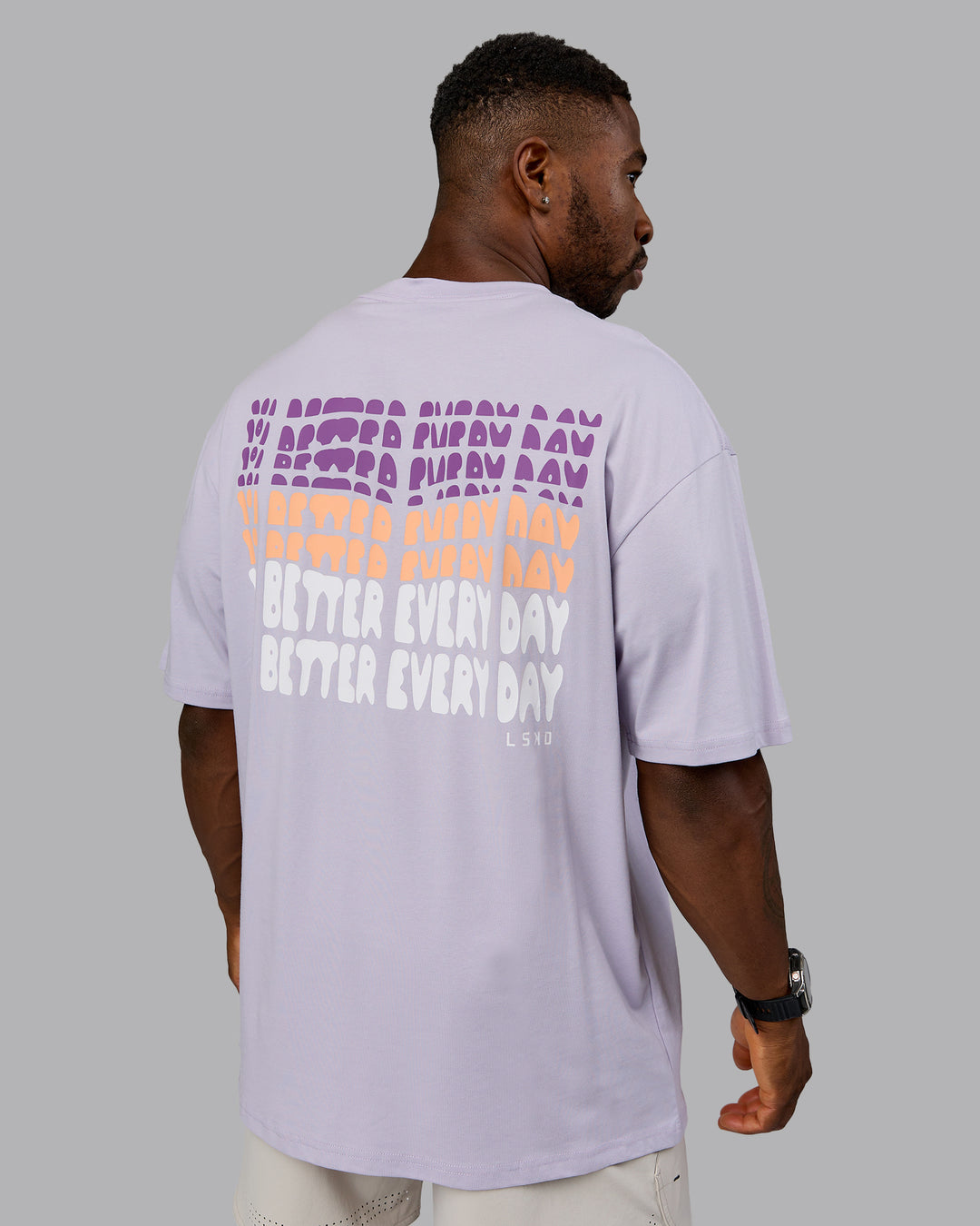 Man wearing On Repeat FLXCotton Oversized Tee - Galactic Lilac-Peach Fuzz | Model:Sam | Size:L