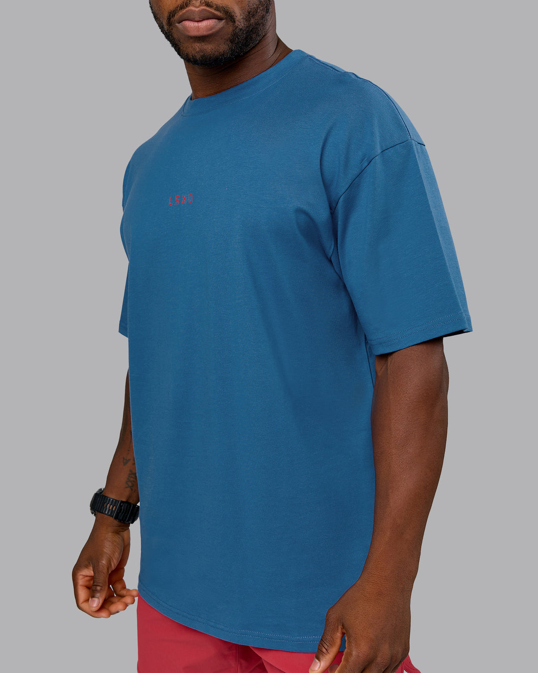 Man wearing On Repeat FLXCotton Oversized Tee - High Tide-Claret | Model:Sam | Size:L