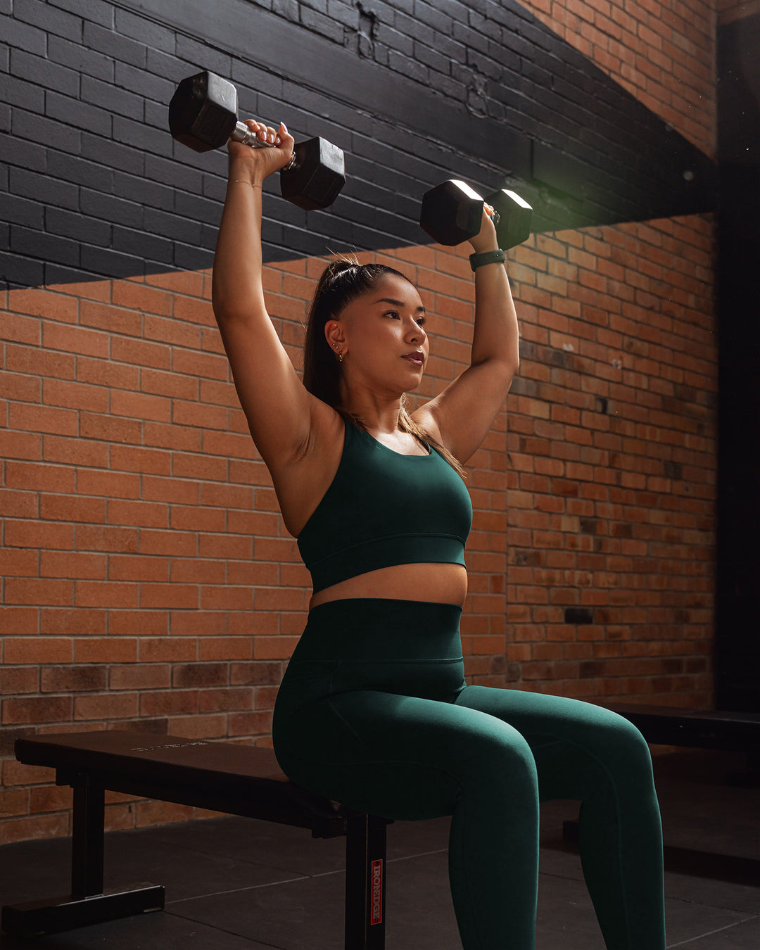 Woman wearing Accelerate Sports Bra - Dark Moss | Model:Gloria | Size:M