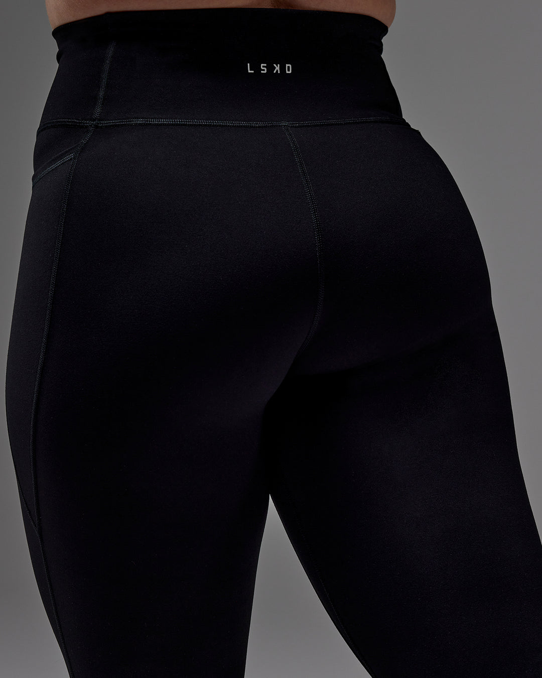Woman wearing Fusion Ultra High-Rise 3/4 Legging Pockets - Black | Model:Caity | Size:M