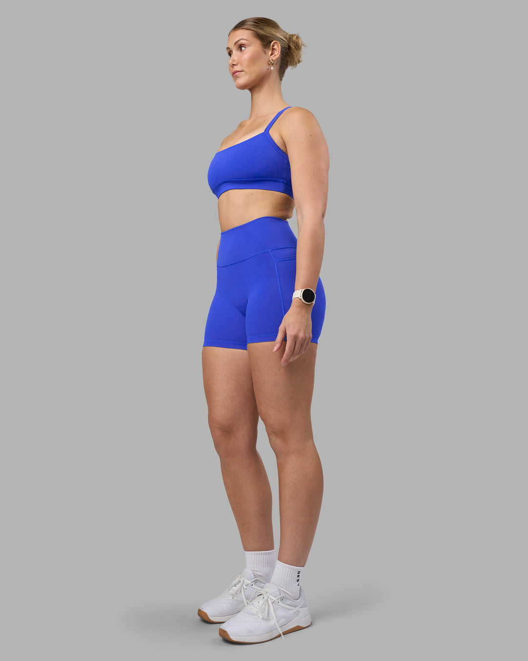 Woman wearing Fusion Ultra High-Rise 4" Short Pockets - Power Cobalt | Model:Amy | Size:M