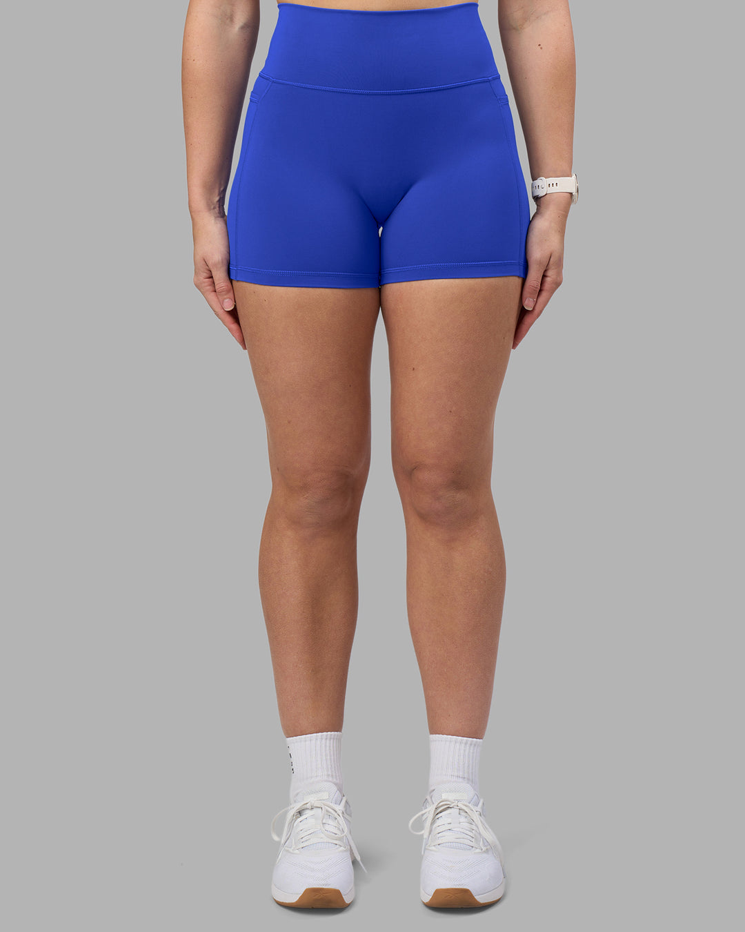 Woman wearing Fusion Ultra High-Rise 4" Short Pockets - Power Cobalt | Model:Amy | Size:M