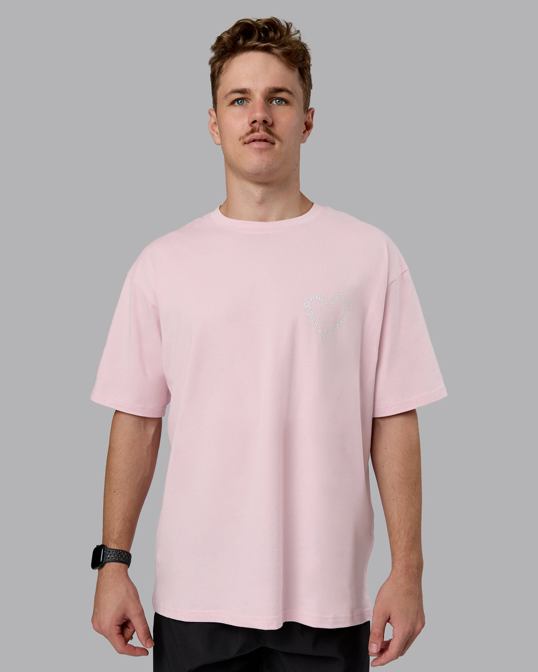Man wearing Love The Process FLXCotton Oversize Tee - Petal Pink-White | Model:Cameron | Size:M