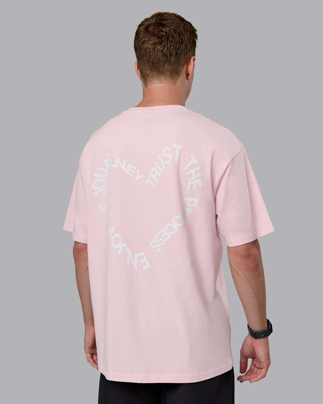 Man wearing Love The Process FLXCotton Oversize Tee - Petal Pink-White | Model:Cameron | Size:M