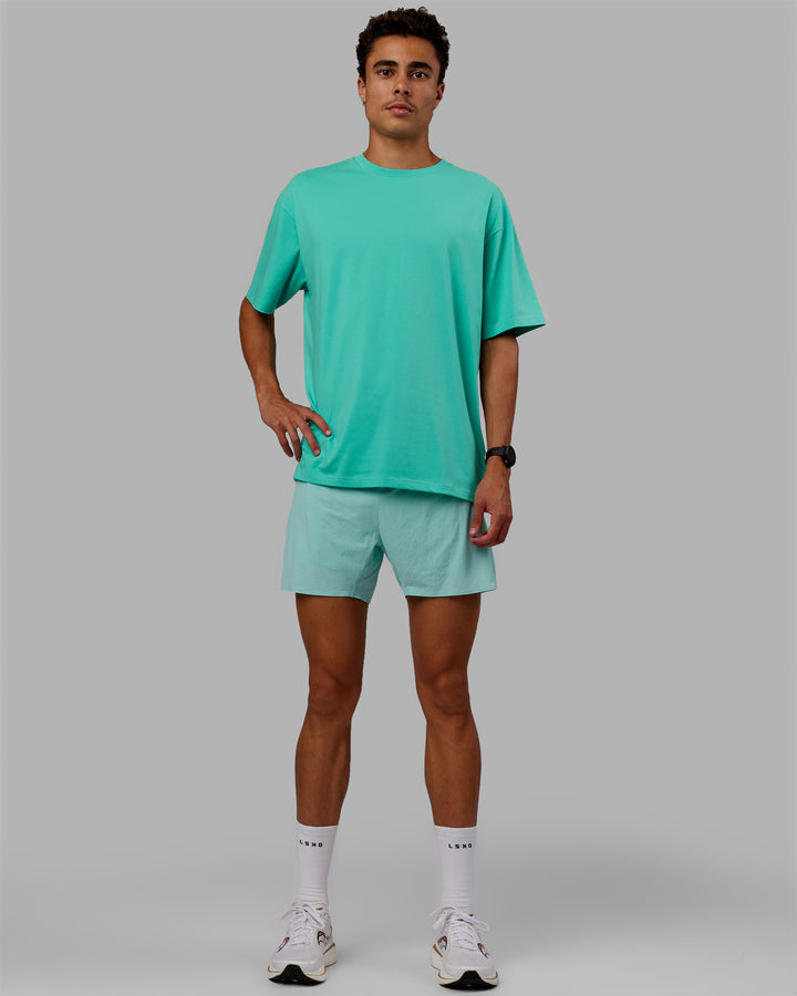 Man wearing Unisex Love The Run FLXCotton Tee Oversize - Aquatic Awe-White