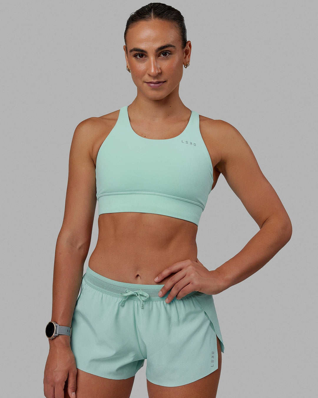 Woman wearing Accelerate Sports Bra - Pastel Turquoise