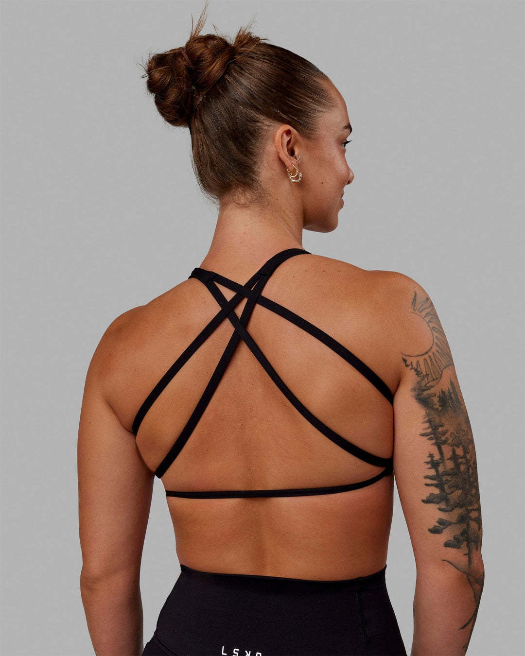 Woman wearing Aspire Sports Bra - Black