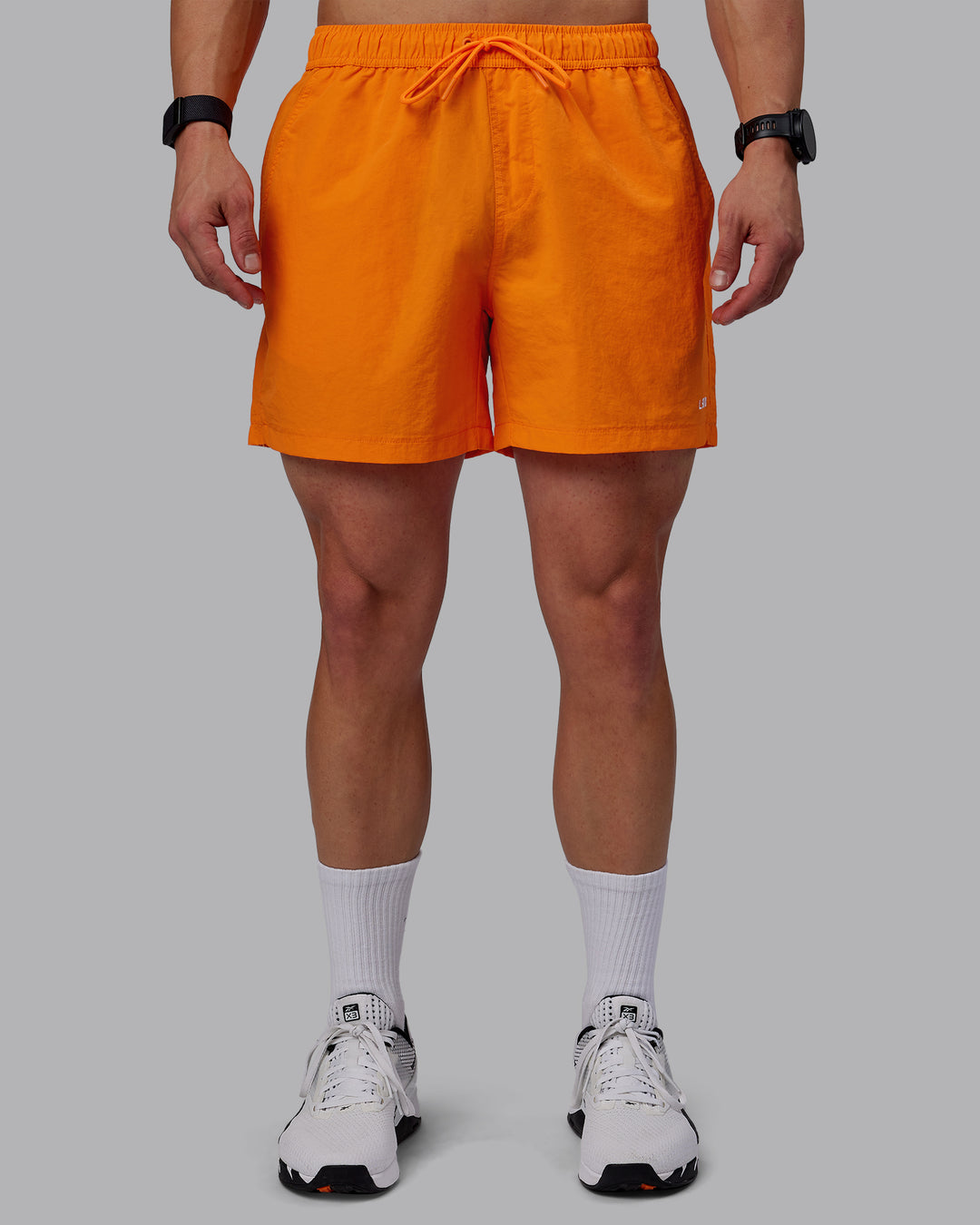 Man wearing Classic 5" Shorts - Vibrant Orange