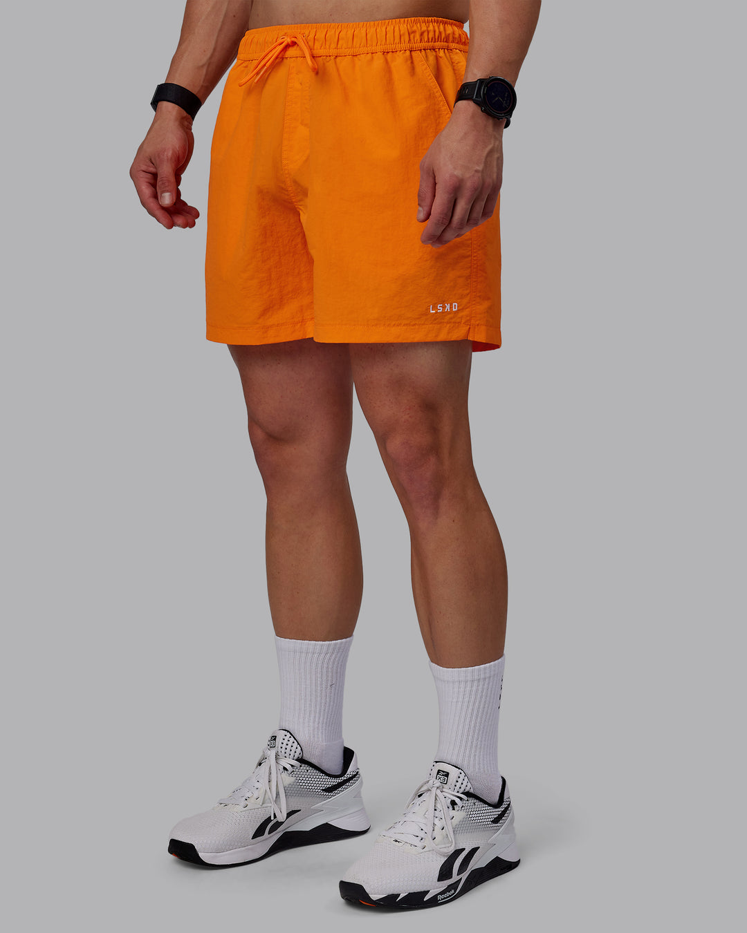 Man wearing Classic 5" Shorts - Vibrant Orange