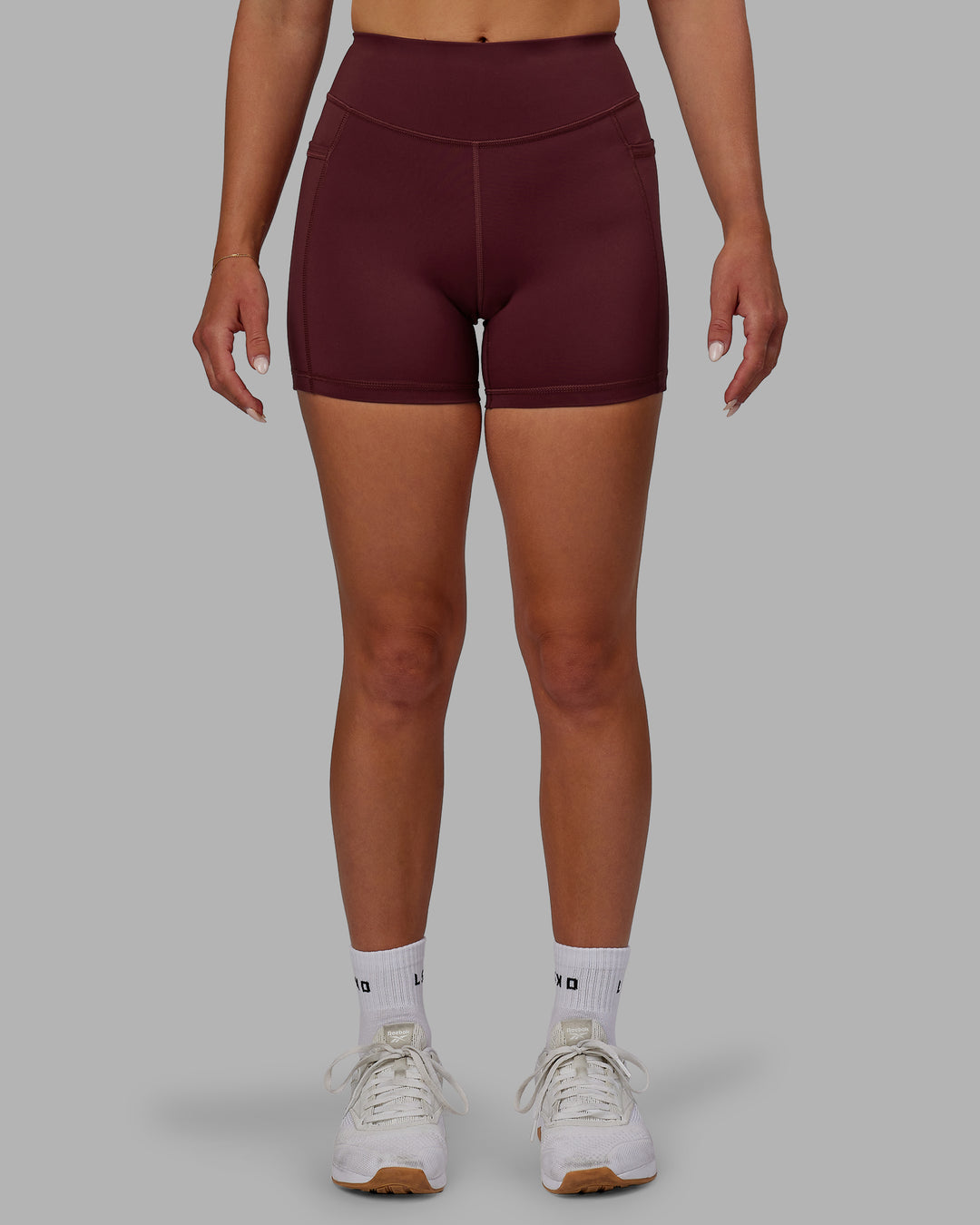 Woman wearing Elite High-Rise 4" Short Pockets - Dark Cherry