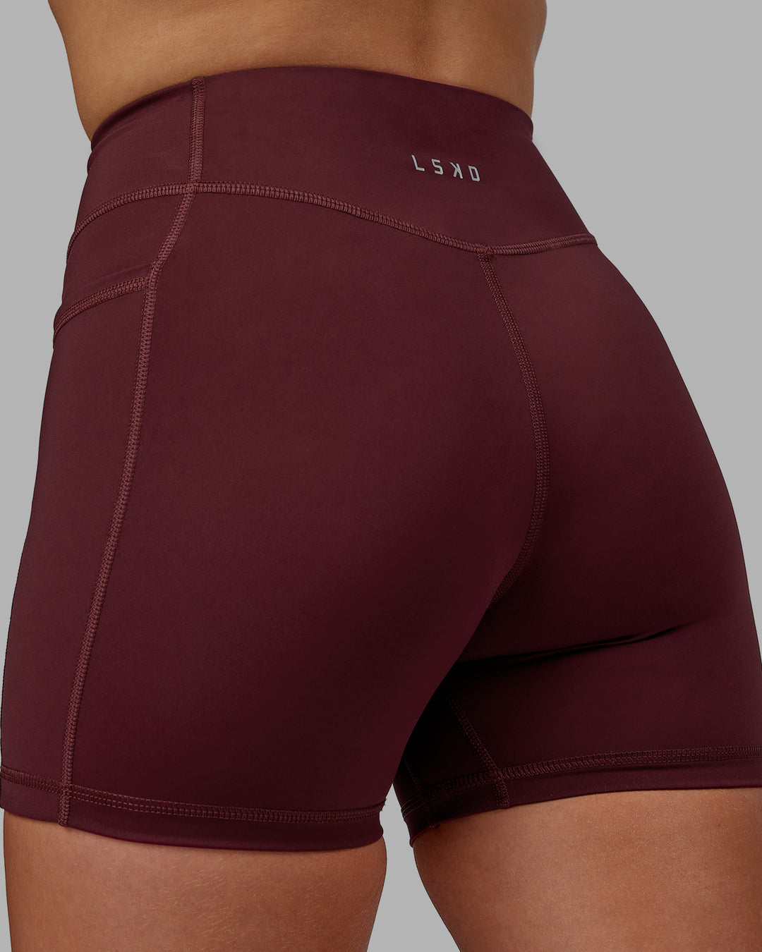 Woman wearing Elite High-Rise 4" Short Pockets - Dark Cherry