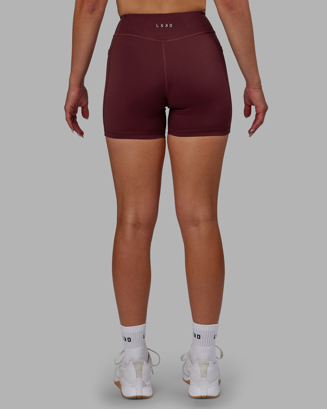 Woman wearing Elite High-Rise 4" Short Pockets - Dark Cherry
