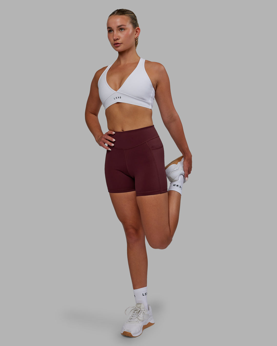 Woman wearing Elite High-Rise 4" Short Pockets - Dark Cherry