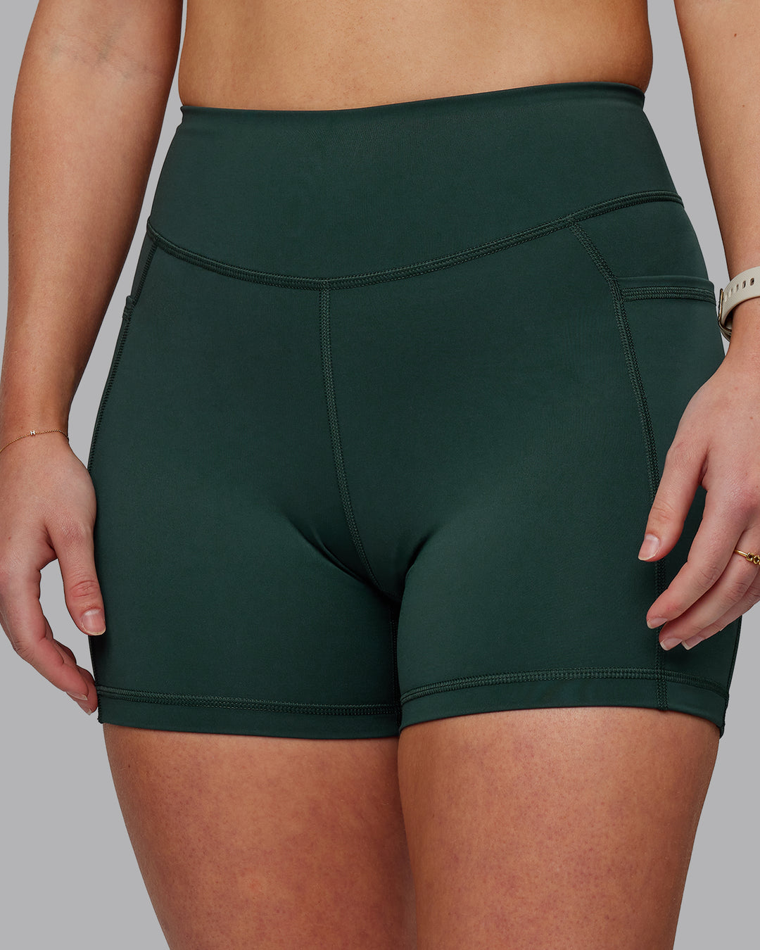 Woman wearing Elite High-Rise 4" Short Pockets - Vital Green