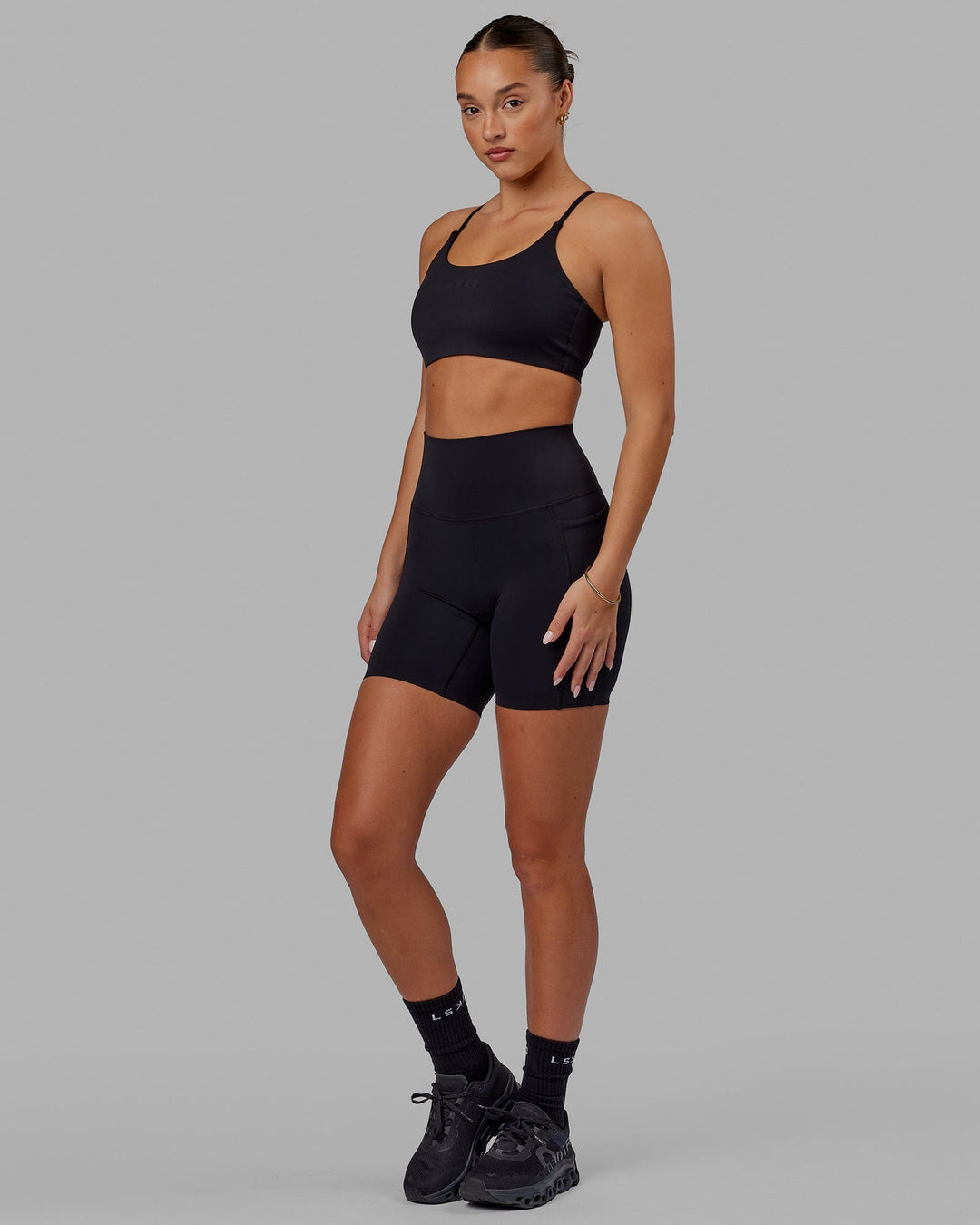 Woman wearing Elixir Mid Short Tight with Pockets - Black