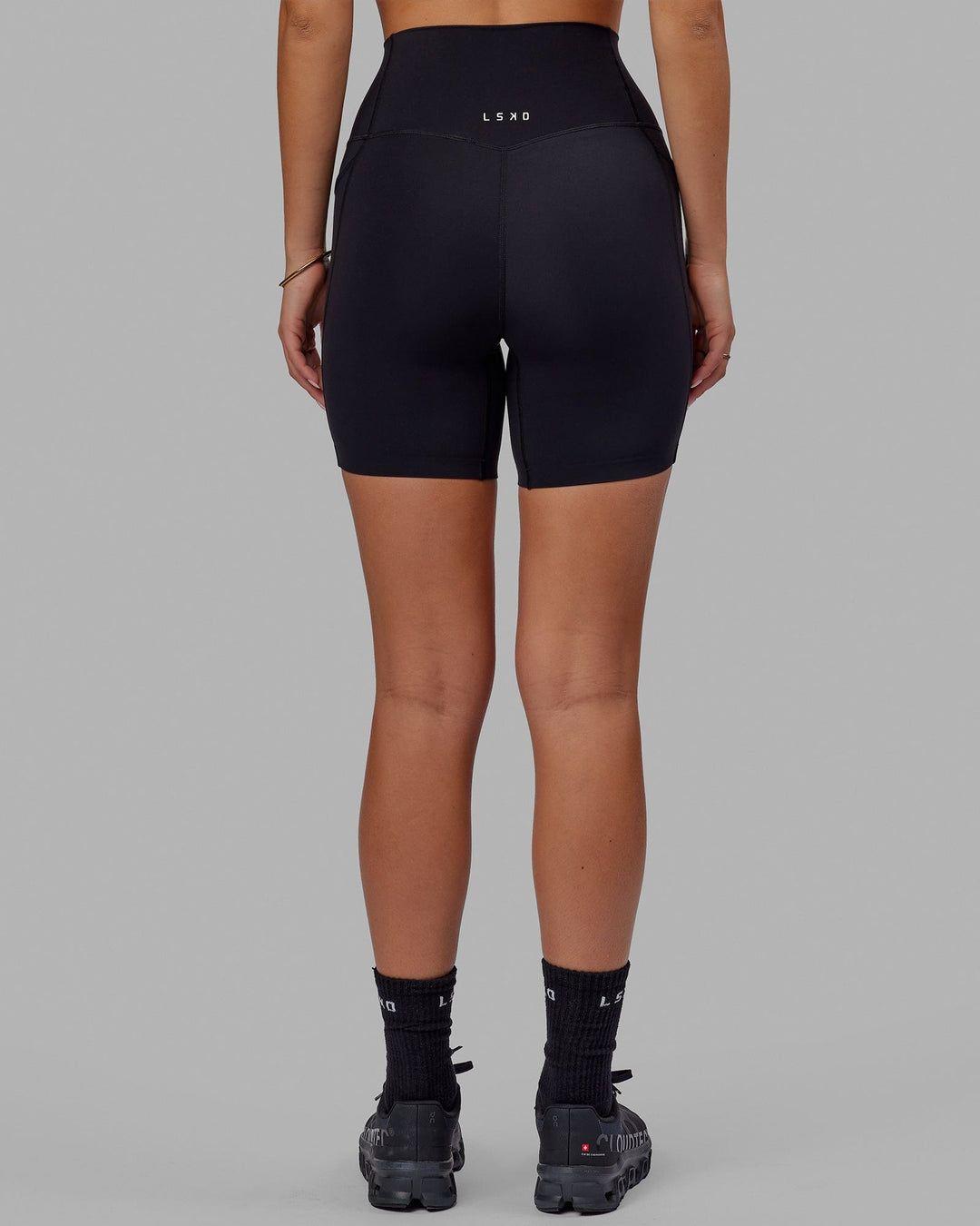 Woman wearing Elixir Mid Short Tight with Pockets - Black