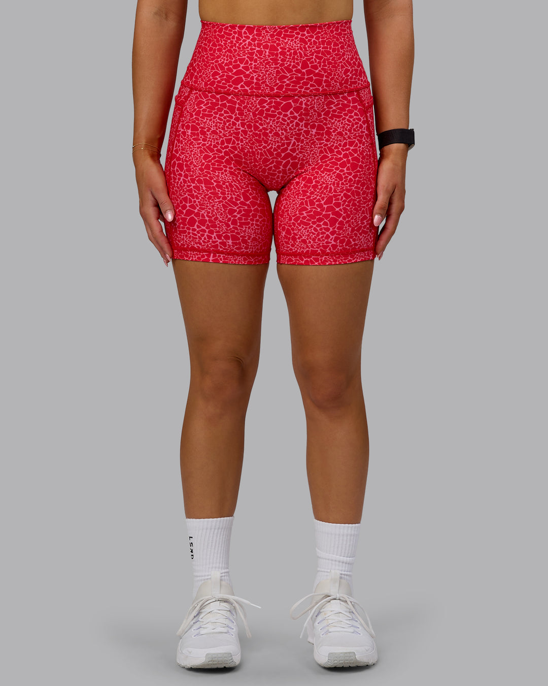 Woman wearing Fusion Ultra High-Rise 6" Short Pockets - Red Vitality Print | Model:Halle | Size:S