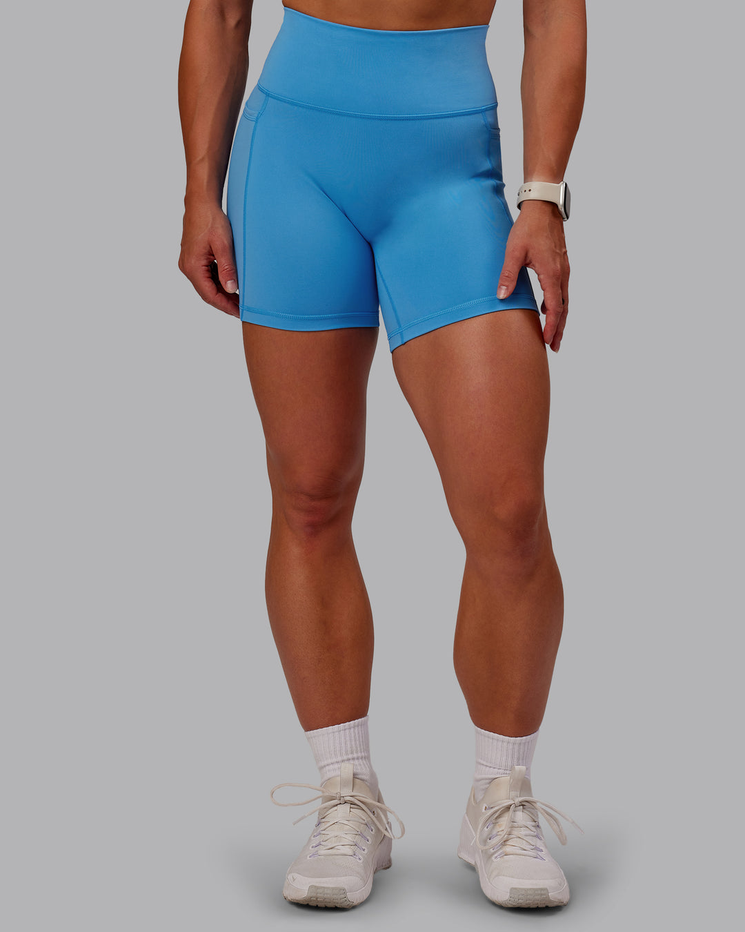 Woman wearing Fusion Ultra High-Rise 6" Short Pockets - Azure Blue | Model:Amber | Size:S