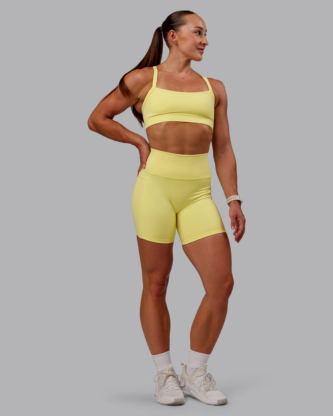 Woman wearing Fusion Ultra High-Rise 6" Short Pockets - Lemon Fizz | Model:Amber | Size:S