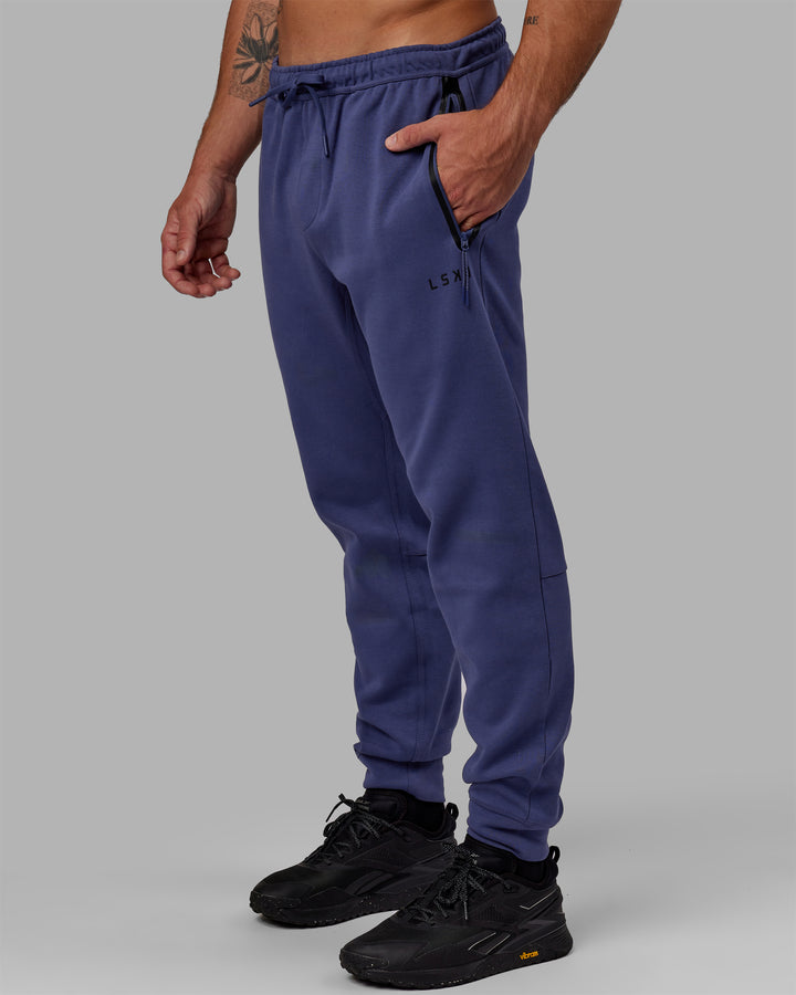 Man wearing Athlete ForgedFleece Zip Track Pants - Future Dusk