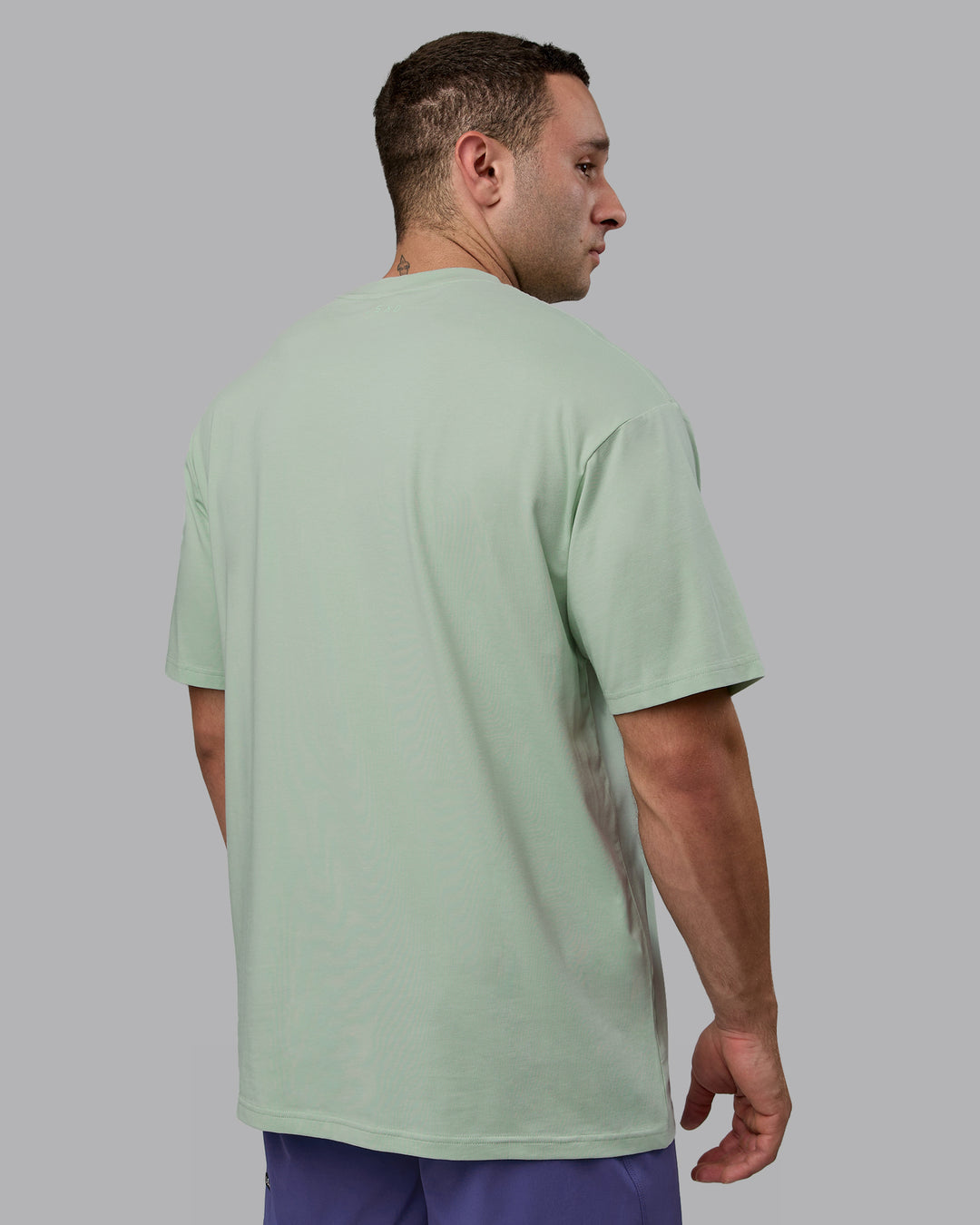 Man wearing Unisex Motion FLXCotton Tee Oversize - Surf Spray-Royal Purple