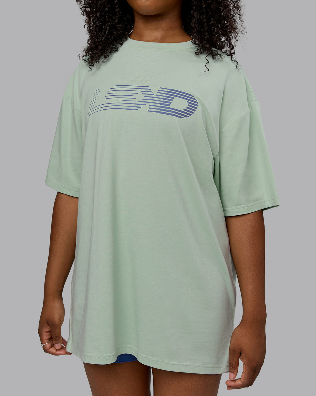 Woman wearing Unisex Motion FLXCotton Tee Oversize - Surf Spray-Royal Purple